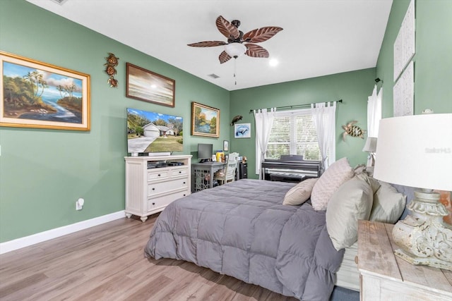 bedroom with ceiling fan and light wood-type flooring