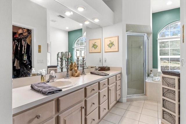 bathroom featuring tile patterned flooring, vanity, and a shower with shower door