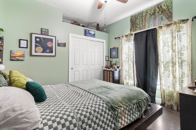 bedroom featuring a closet, ceiling fan, hardwood / wood-style floors, and multiple windows