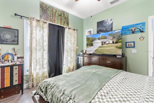 bedroom with light hardwood / wood-style floors and ceiling fan