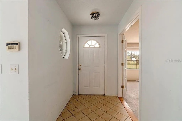 doorway to outside featuring light tile patterned floors