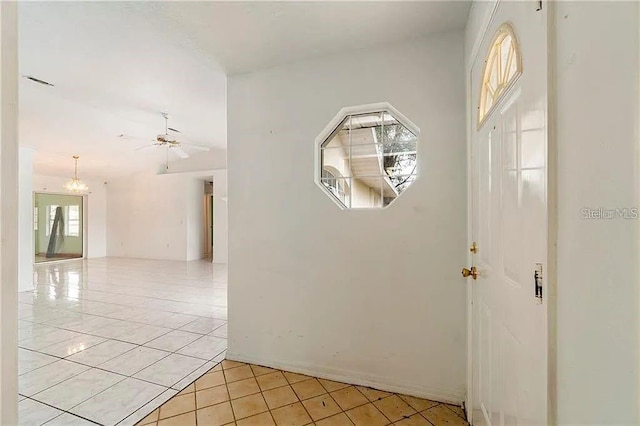 foyer entrance with plenty of natural light, ceiling fan, and light tile patterned floors