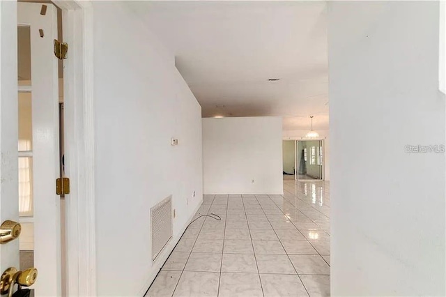 hall with light tile patterned flooring