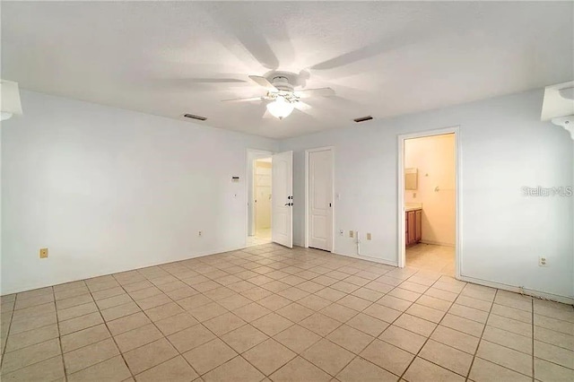 tiled empty room with ceiling fan