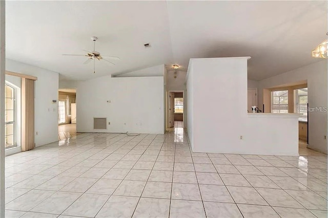 unfurnished living room featuring vaulted ceiling, ceiling fan, and light tile patterned flooring