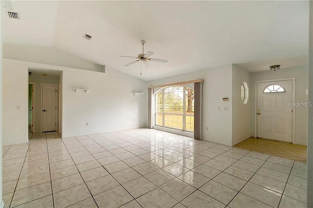 interior space featuring light tile patterned floors, vaulted ceiling, and ceiling fan