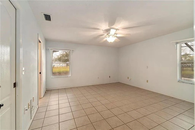 tiled empty room with ceiling fan