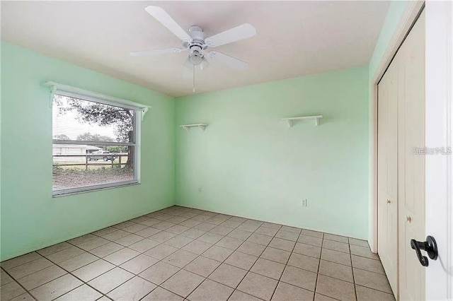 spare room featuring ceiling fan and light tile patterned flooring