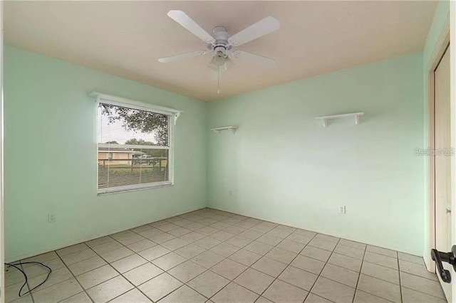 empty room featuring ceiling fan and light tile patterned floors