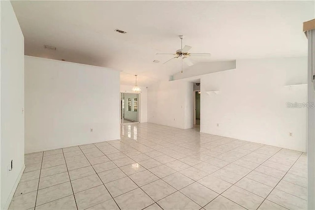 unfurnished room with ceiling fan, light tile patterned flooring, and vaulted ceiling