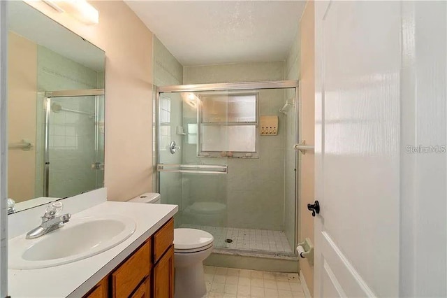 bathroom with vanity, toilet, and walk in shower