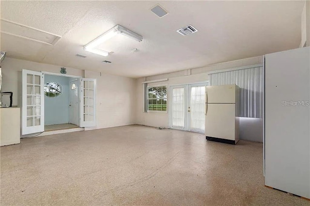 unfurnished room featuring french doors