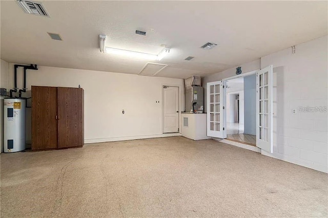 garage featuring electric water heater and water heater