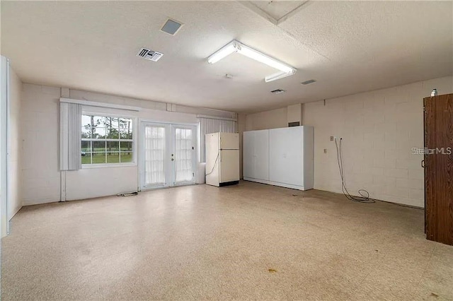 unfurnished room featuring a textured ceiling