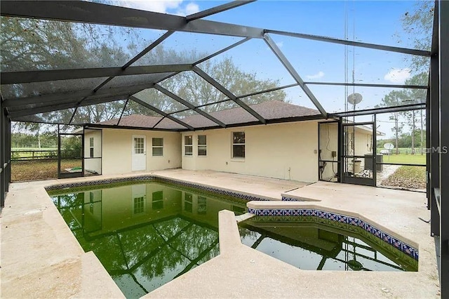 view of swimming pool featuring a patio and a lanai