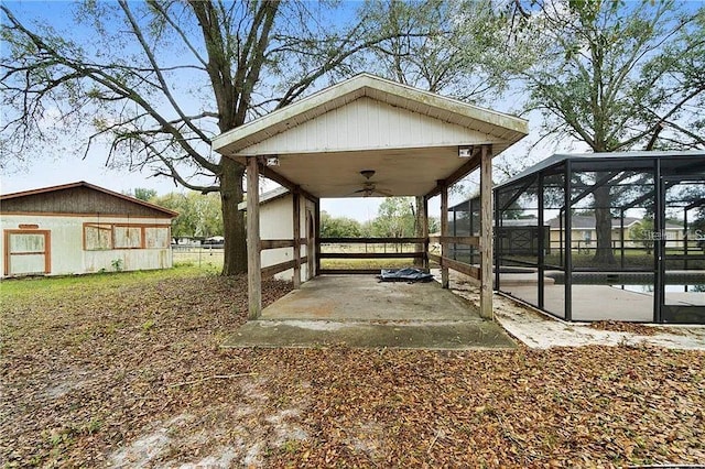 view of yard with ceiling fan, a lanai, and a swimming pool