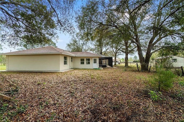 rear view of property with a sunroom