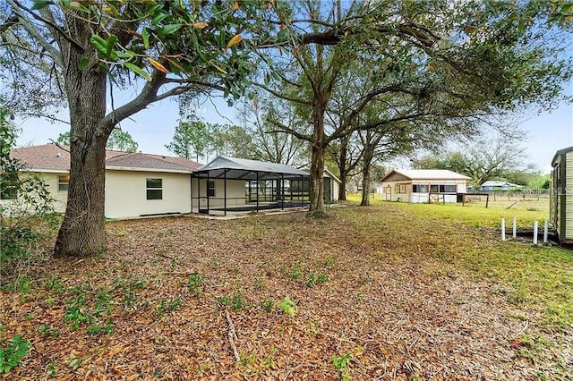 view of yard featuring glass enclosure