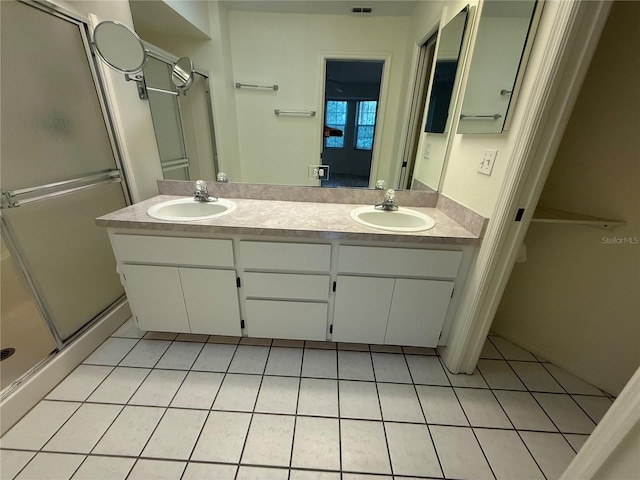 bathroom featuring vanity, an enclosed shower, and tile patterned flooring