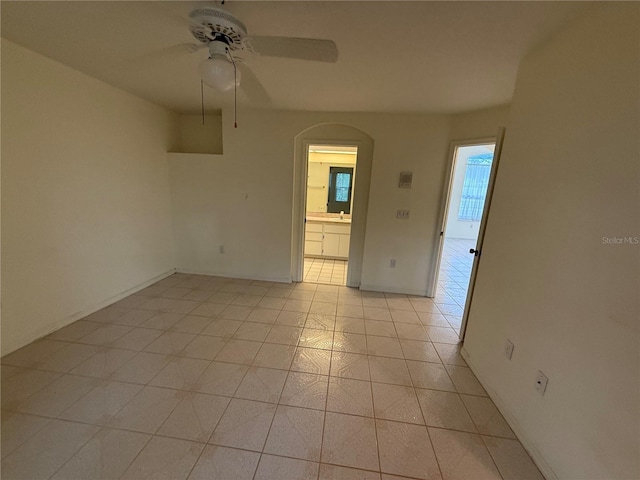 tiled empty room with ceiling fan