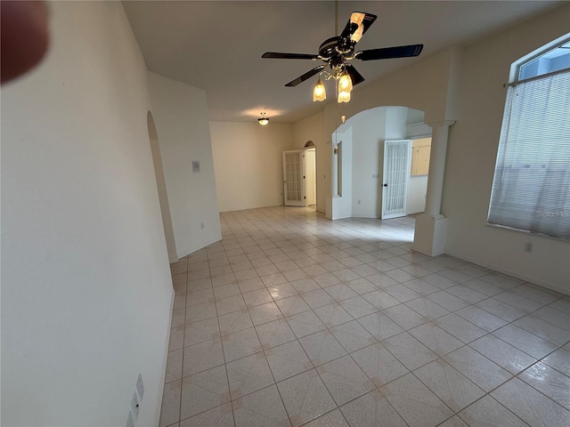 tiled spare room with ceiling fan