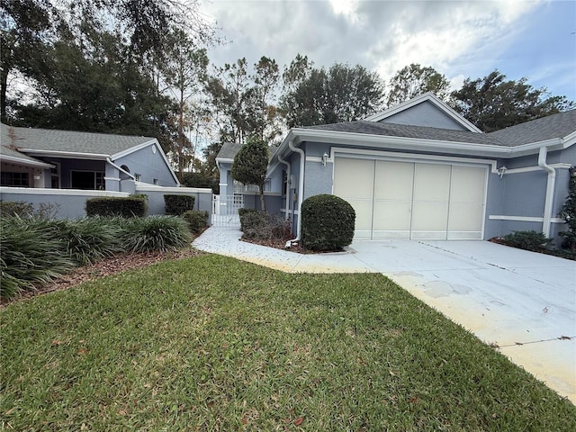 view of side of property featuring a yard and a garage