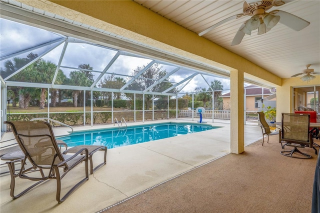 view of swimming pool featuring a lanai, a patio area, and ceiling fan