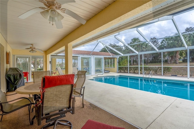 view of pool with ceiling fan, a patio area, and a lanai