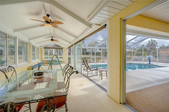 sunroom featuring ceiling fan, a swimming pool, and lofted ceiling with beams