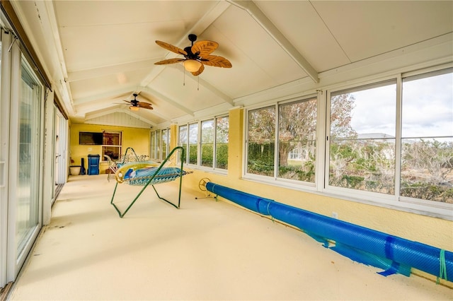 sunroom featuring vaulted ceiling with beams and ceiling fan