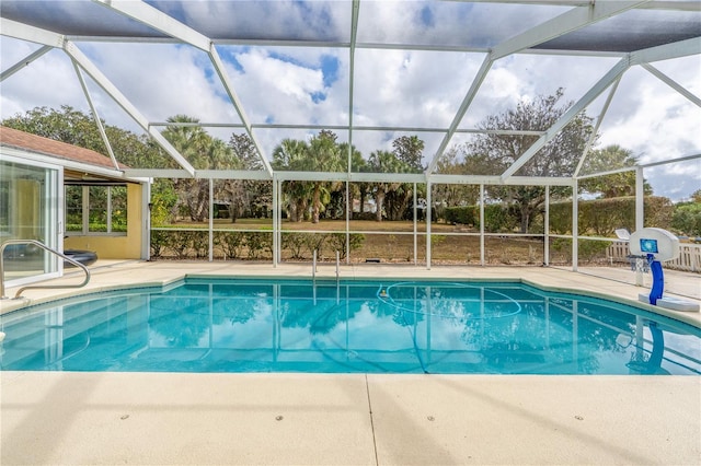 view of swimming pool with a patio and a lanai