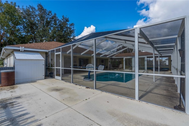 view of pool featuring glass enclosure and a patio