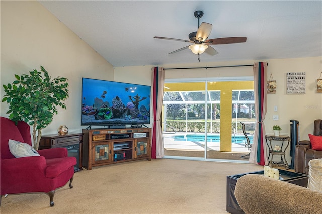 carpeted living room with vaulted ceiling and ceiling fan