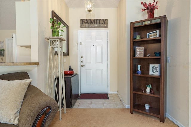 view of carpeted foyer entrance