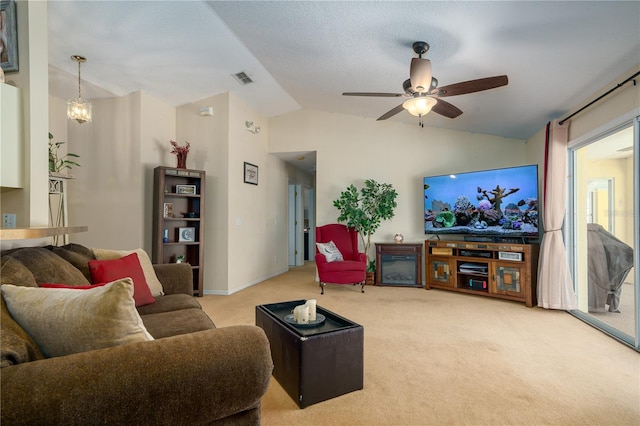 living room with ceiling fan with notable chandelier, light carpet, and vaulted ceiling