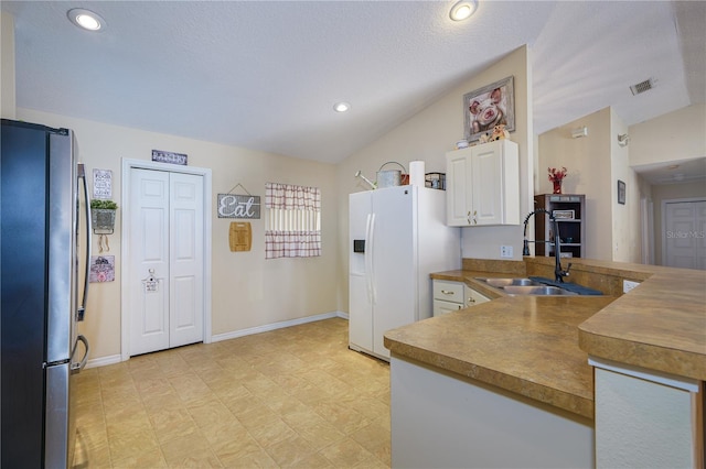 kitchen with lofted ceiling, white fridge with ice dispenser, sink, and stainless steel refrigerator