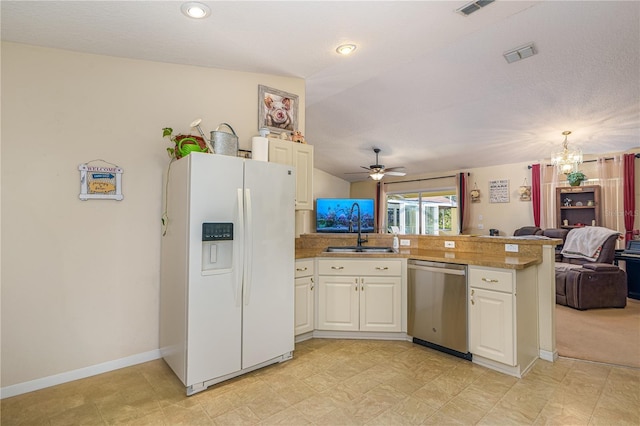 kitchen with white fridge with ice dispenser, sink, stainless steel dishwasher, kitchen peninsula, and ceiling fan with notable chandelier