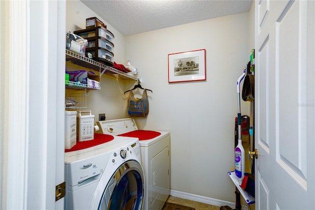 laundry room with washer and dryer and a textured ceiling