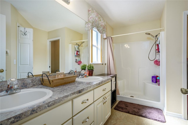 bathroom with tile patterned floors, a shower with curtain, and vanity