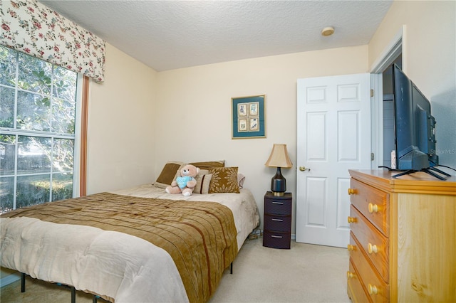 carpeted bedroom featuring a textured ceiling