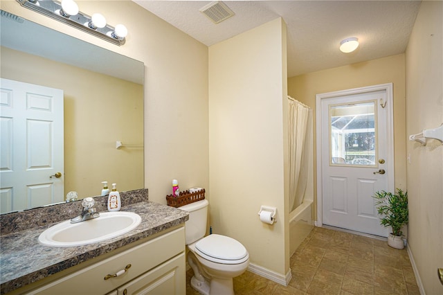 full bathroom featuring vanity, toilet, a textured ceiling, and shower / tub combo with curtain