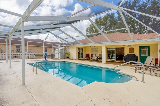 outdoor pool featuring a patio, area for grilling, glass enclosure, fence, and ceiling fan