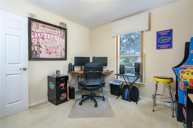 office area featuring light carpet, a textured ceiling, and baseboards