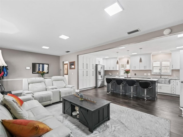 living room featuring dark hardwood / wood-style floors and sink