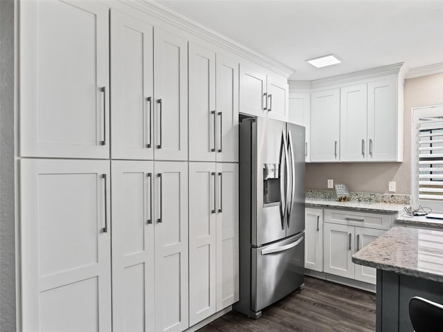 kitchen featuring white cabinets, light stone countertops, and stainless steel fridge with ice dispenser