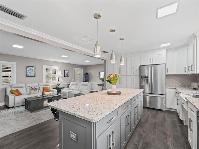 kitchen featuring stainless steel refrigerator with ice dispenser, decorative light fixtures, a kitchen island, dark hardwood / wood-style flooring, and white cabinetry