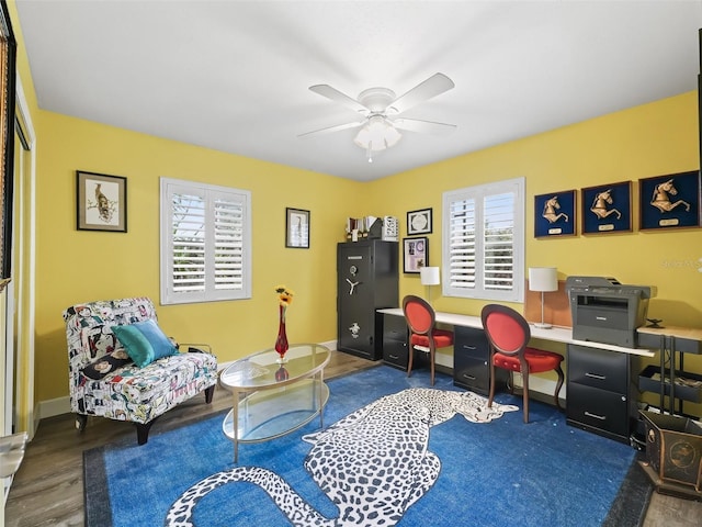 home office with dark hardwood / wood-style flooring, ceiling fan, and plenty of natural light