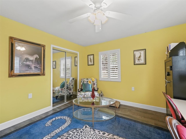 living area with hardwood / wood-style floors and ceiling fan