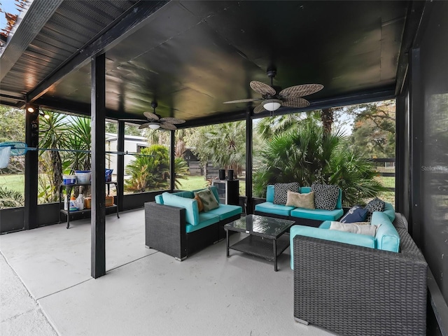 sunroom featuring ceiling fan