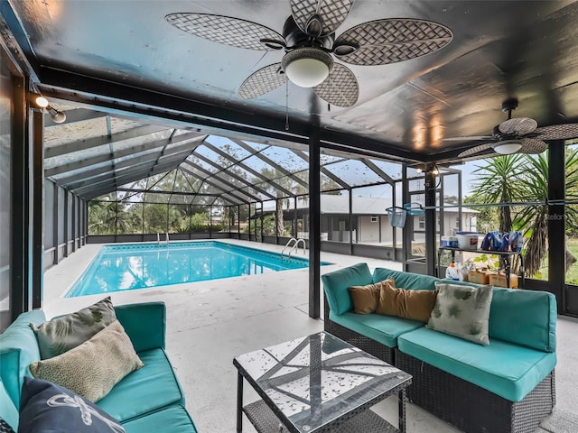 view of swimming pool with a lanai, a patio area, and an outdoor living space